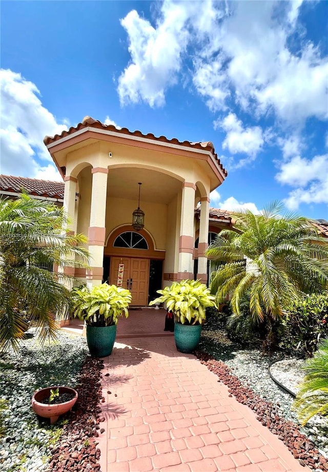 12022 Classic Dr, Coral Springs, FL 33071 - property entrance with a tile roof and stucco siding
