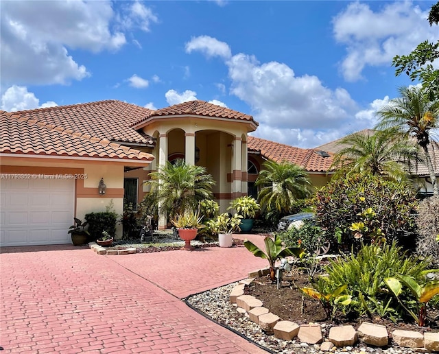 12022 Classic Dr, Coral Springs, FL 33071 - mediterranean / spanish home featuring a tile roof, a garage, stucco siding, and decorative driveway