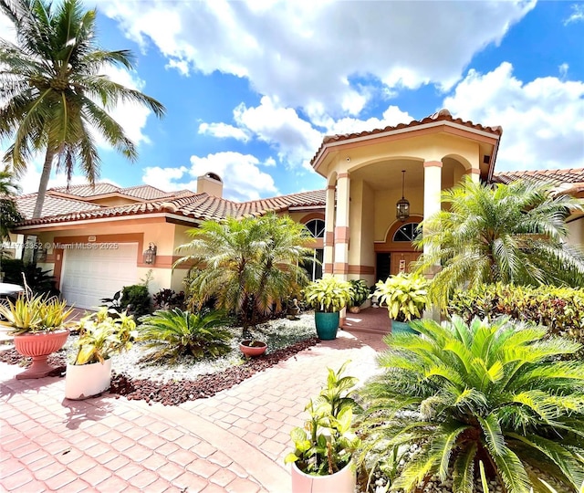 12022 Classic Dr, Coral Springs, FL 33071 - view of front of house featuring stucco siding, a tile roof, a chimney, and an attached garage