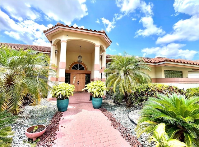 12022 Classic Dr, Coral Springs, FL 33071 - doorway to property featuring stucco siding and a tiled roof