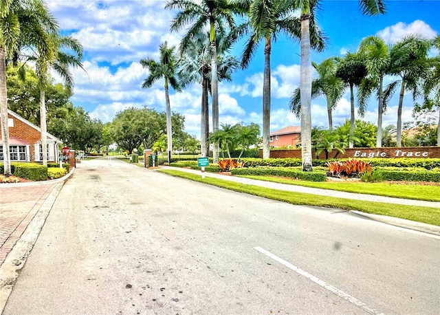 12022 Classic Dr, Coral Springs, FL 33071 - view of asphalt road featuring sidewalks, curbs, and traffic signs
