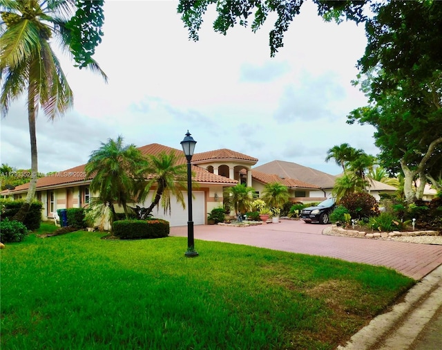 12022 Classic Dr, Coral Springs, FL 33071 - mediterranean / spanish-style house featuring a garage, concrete driveway, stucco siding, a tiled roof, and a front lawn