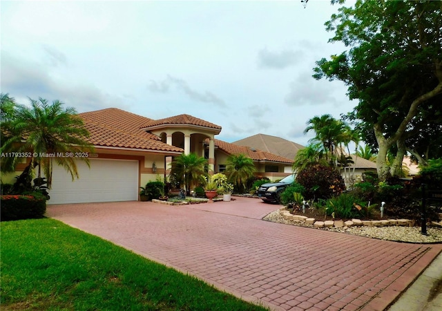 12022 Classic Dr, Coral Springs, FL 33071 - mediterranean / spanish home with decorative driveway, a garage, a tiled roof, and stucco siding