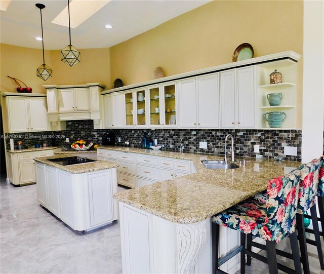 12022 Classic Dr, Coral Springs, FL 33071 - kitchen with tasteful backsplash, open shelves, black electric stovetop, a peninsula, and recessed lighting