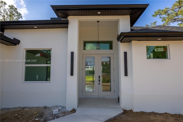 entrance to property with stucco siding and french doors