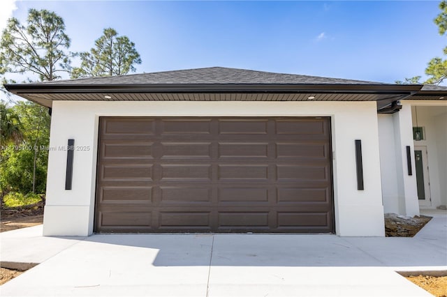 garage with concrete driveway