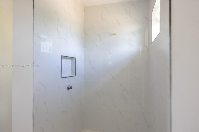 full bathroom with a marble finish shower