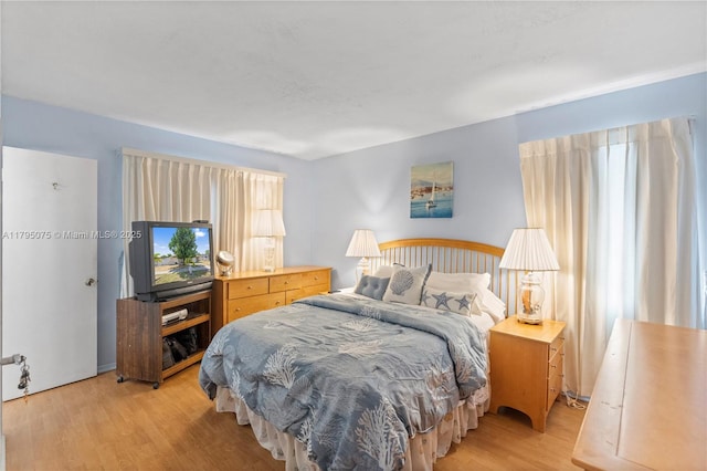 bedroom featuring light wood-style floors and multiple windows