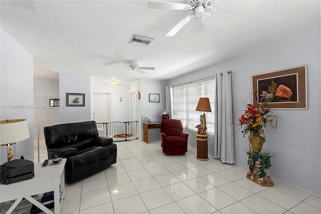 living room featuring visible vents, ceiling fan, and light tile patterned floors