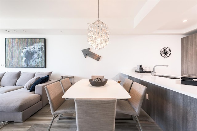 dining space with an inviting chandelier and wood finished floors