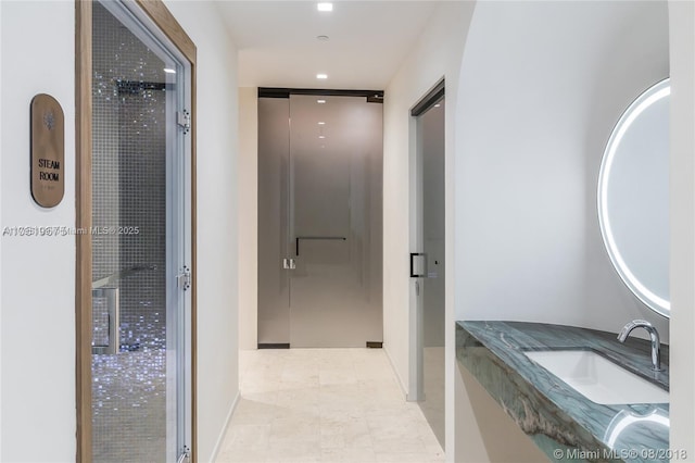 bathroom with baseboards, tile patterned flooring, and vanity