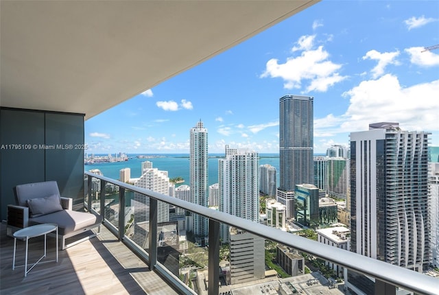 balcony with a water view and a city view