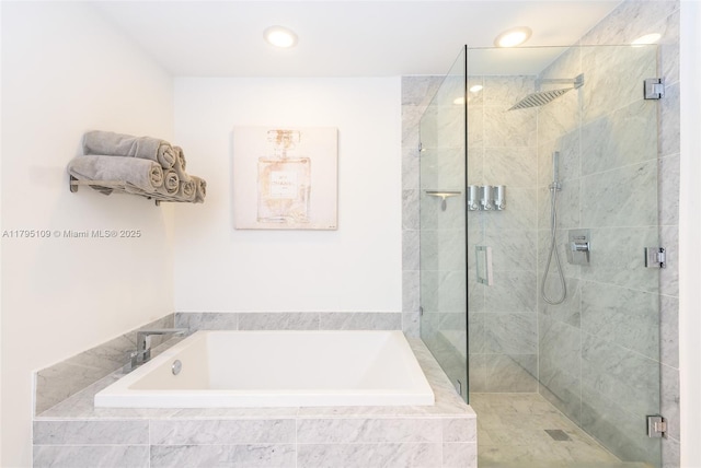 full bath with recessed lighting, a shower stall, and a garden tub
