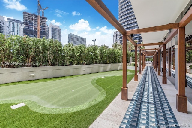 view of yard with fence and golf course view