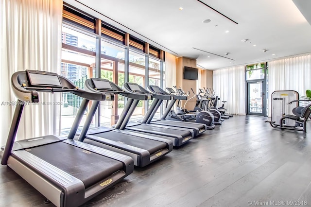exercise room with recessed lighting, expansive windows, and wood finished floors