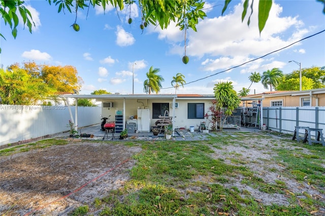 617 W 33rd St, Hialeah, FL 33012 - back of house with a fenced backyard, stucco siding, and a patio area