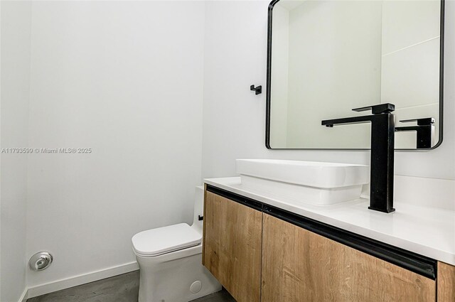 2730 SW 17th Ave, Miami, FL 33133 - half bath featuring vanity, baseboards, and toilet