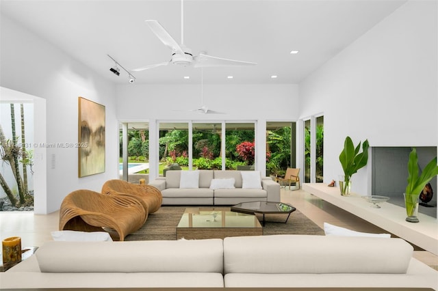 living area featuring recessed lighting, a ceiling fan, and wood finished floors