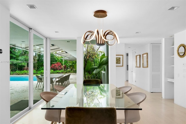 dining space with a wall of windows, plenty of natural light, and visible vents