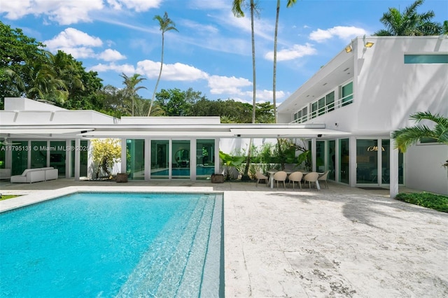 outdoor pool featuring a patio area and outdoor dry bar