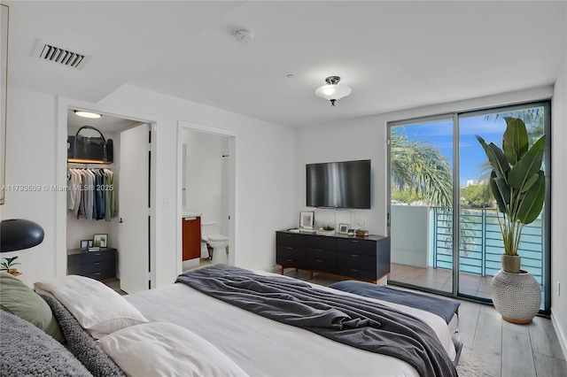 171 N Shore Dr Unit 171-1, Miami Beach, FL 33141 - bedroom featuring access to outside, visible vents, light wood-type flooring, and ensuite bath