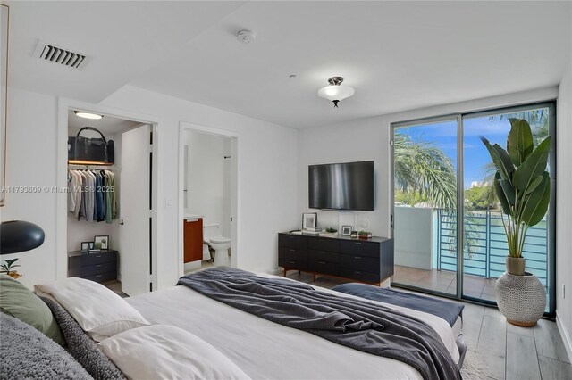 171 N Shore Dr Unit 171-1, Miami Beach, FL 33141 - bedroom with access to exterior, ensuite bathroom, and light wood-type flooring