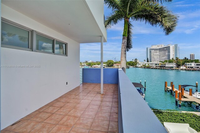 171 N Shore Dr Unit 171-1, Miami Beach, FL 33141 - view of patio with a water view, a balcony, and a boat dock