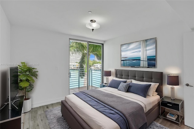 171 N Shore Dr Unit 171-1, Miami Beach, FL 33141 - bedroom with baseboards, wood finished floors, and access to exterior