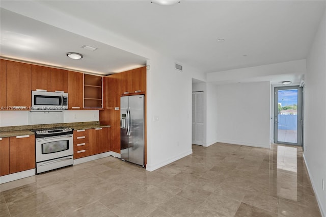 171 N Shore Dr Unit 171-1, Miami Beach, FL 33141 - kitchen featuring open shelves, brown cabinetry, stainless steel appliances, baseboards, and visible vents