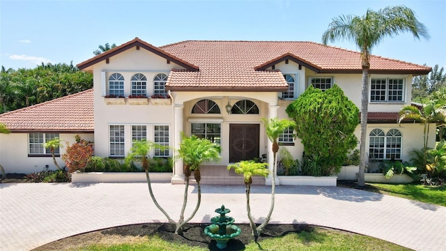 12360 SW 1st St, Plantation, FL 33325 - mediterranean / spanish house with stucco siding and a tiled roof
