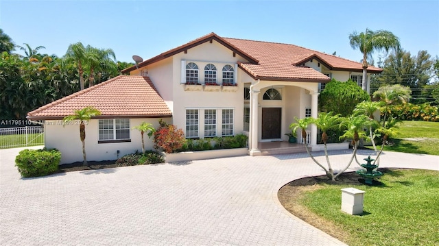 12360 SW 1st St, Plantation, FL 33325 - mediterranean / spanish-style house featuring a tile roof, stucco siding, and curved driveway