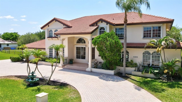 12360 SW 1st St, Plantation, FL 33325 - mediterranean / spanish home with a tile roof, stucco siding, decorative driveway, and a front yard