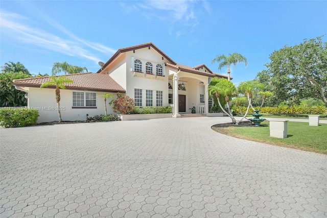 12360 SW 1st St, Plantation, FL 33325 - mediterranean / spanish home with curved driveway, a tile roof, and stucco siding