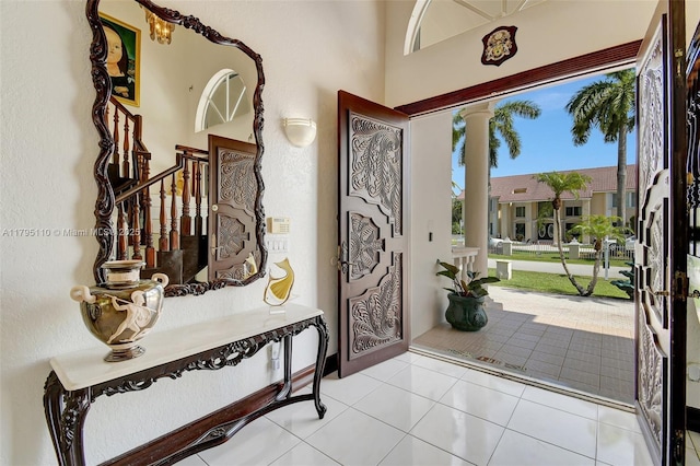12360 SW 1st St, Plantation, FL 33325 - entrance foyer featuring decorative columns, tile patterned floors, and stairway