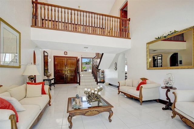 12360 SW 1st St, Plantation, FL 33325 - living room with a towering ceiling, stairs, light tile patterned floors, and baseboards
