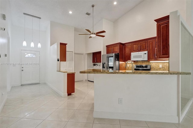 9751 Malvern Dr, Tamarac, FL 33321 - kitchen with a ceiling fan, stainless steel appliances, a peninsula, and a towering ceiling