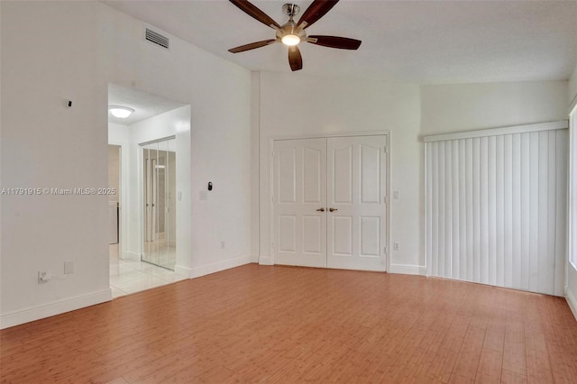 9751 Malvern Dr, Tamarac, FL 33321 - interior space featuring light wood finished floors, a ceiling fan, baseboards, lofted ceiling, and visible vents