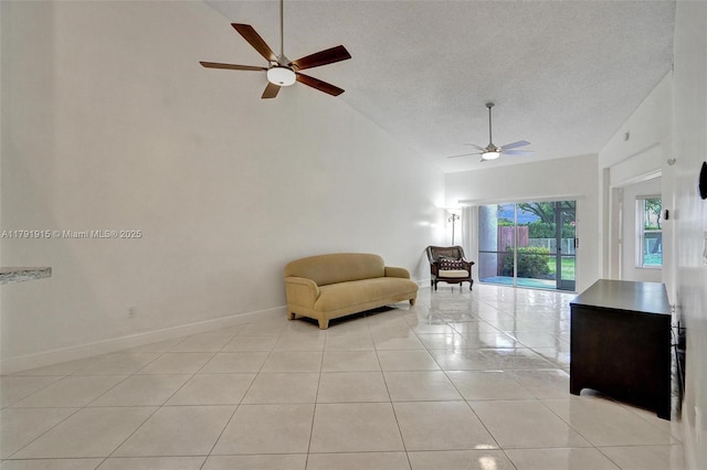 9751 Malvern Dr, Tamarac, FL 33321 - living area with light tile patterned flooring, high vaulted ceiling, a textured ceiling, a ceiling fan, and baseboards