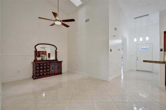 9751 Malvern Dr, Tamarac, FL 33321 - empty room featuring baseboards, a ceiling fan, light tile patterned floors, and a high ceiling