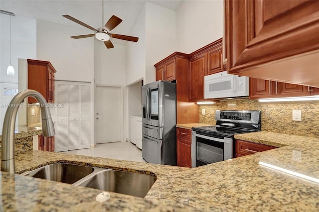 9751 Malvern Dr, Tamarac, FL 33321 - kitchen with tasteful backsplash, high vaulted ceiling, ceiling fan, light stone countertops, and appliances with stainless steel finishes