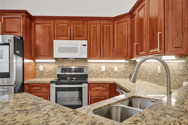 9751 Malvern Dr, Tamarac, FL 33321 - kitchen featuring backsplash, stainless steel appliances, light stone counters, and a sink