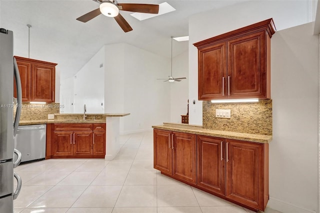 9751 Malvern Dr, Tamarac, FL 33321 - kitchen with a ceiling fan, light stone countertops, a peninsula, tasteful backsplash, and appliances with stainless steel finishes