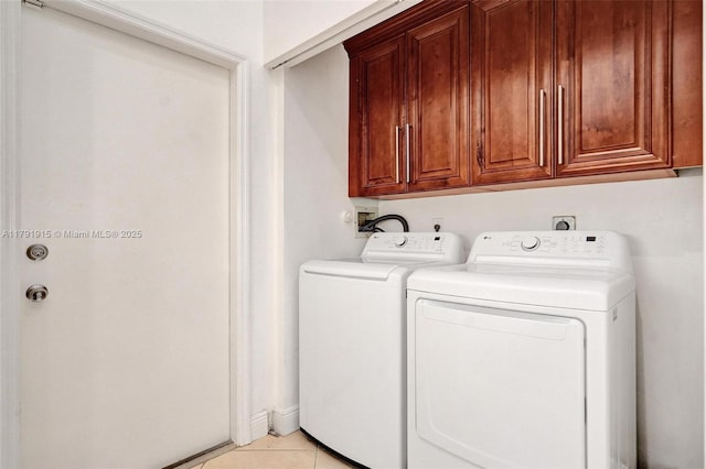 9751 Malvern Dr, Tamarac, FL 33321 - clothes washing area featuring light tile patterned floors, washing machine and dryer, and cabinet space