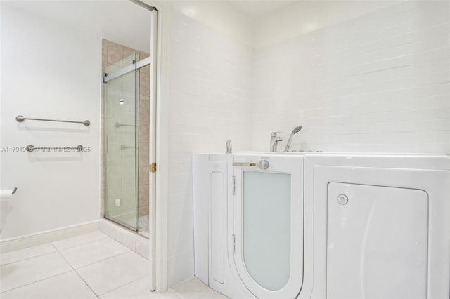 9751 Malvern Dr, Tamarac, FL 33321 - full bath featuring a stall shower, a bathtub, washer / dryer, and tile patterned floors