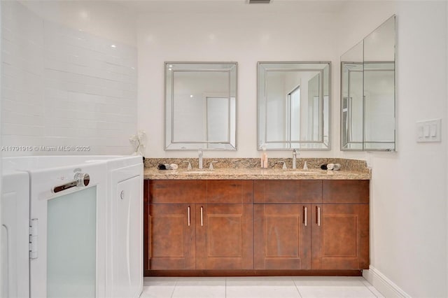 9751 Malvern Dr, Tamarac, FL 33321 - bathroom featuring double vanity, tile patterned flooring, baseboards, and a sink