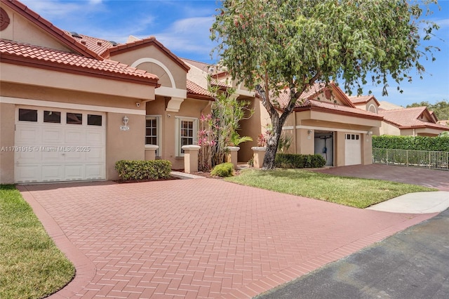 9751 Malvern Dr, Tamarac, FL 33321 - mediterranean / spanish home with decorative driveway, stucco siding, and a garage