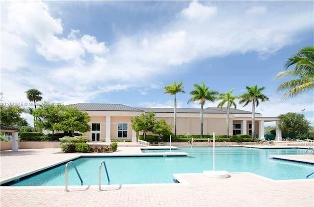 9751 Malvern Dr, Tamarac, FL 33321 - community pool featuring a patio area and a hot tub