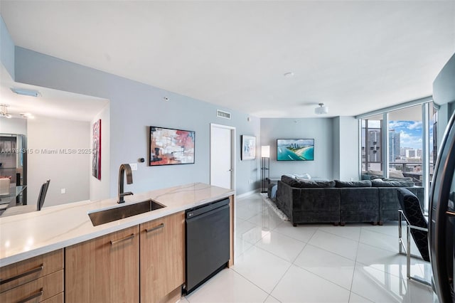 kitchen featuring visible vents, open floor plan, black dishwasher, a sink, and light tile patterned floors