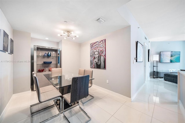 tiled dining space with baseboards, visible vents, and an inviting chandelier