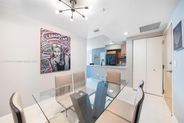 dining area featuring an inviting chandelier, tile patterned flooring, and visible vents